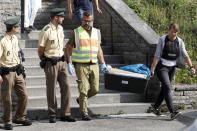 <p>Police officers leave a former hotel where a Syrian man lived before the explosion in Ansbach, Germany, Monday, July 25, 2016. (AP Photo/Matthias Schrader)</p>