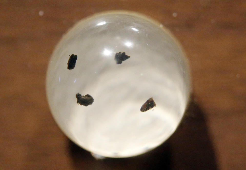 In this Wednesday, Aug. 22, 2018, photo, shows moon rocks encased in acrylic and mounted on a wooden plaque at the Clark Planetarium, in Salt Lake City. A former NASA investigator who has spent more than a decade tracking missing moon rocks is closing in on his goal of finding all 50 lunar samples gifted to U.S. states after Neil Armstrong's first steps on the moon. In recent weeks, two more of the moon rocks that dropped off the radar after the 1969 Apollo 11 mission have been located in Louisiana and Utah. (AP Photo/Rick Bowmer)