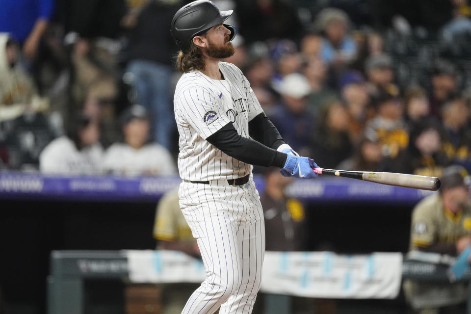 Colorado Rockies' Brendan Rodgers watches his grand slam off San Diego Padres starting pitcher Michael King during the fourth inning of a baseball game Tuesday, April 23, 2024, in Denver. (AP Photo/David Zalubowski)