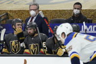 Vegas Golden Knights general manager Kelly McCrimmon, back left, coaches against the St. Louis Blues during the second period of an NHL hockey game Tuesday, Jan. 26, 2021, in Las Vegas. McCrimmon coached the team because the team's coaching staff was isolating due to COVID-19 protocols. (AP Photo/John Locher)