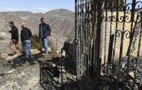 From left, L.A. Mayor Eric Garcetti, L.A. City Councilman Mike Bonin and California Governor Gavin Newsom view a burned and home along Tigertail Road in Brentwood, Calif., Tuesday Oct. 29, 2019. (Wally Skalij/Los Angeles Times via AP, Pool)