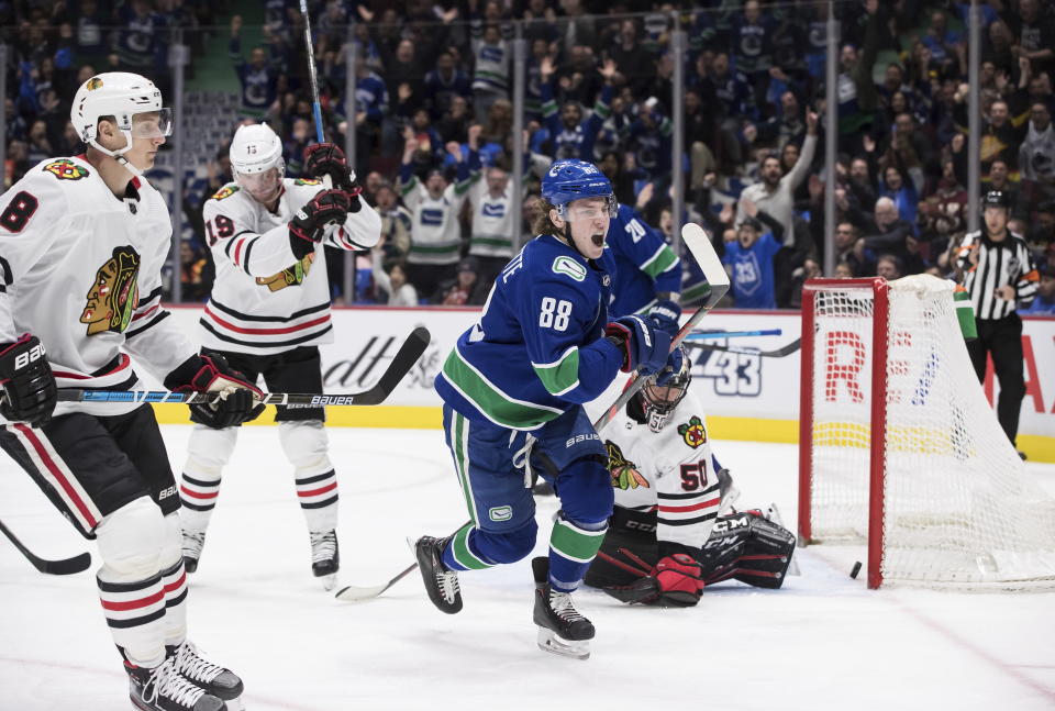 Vancouver Canucks' Adam Gaudette (88) celebrates his goal against Chicago Blackhawks goalie Corey Crawford (50) during the second period of an NHL hockey game Wednesday, Feb. 12, 2020, in Vancouver, British Columbia. (Darryl Dyck/The Canadian Press via AP)