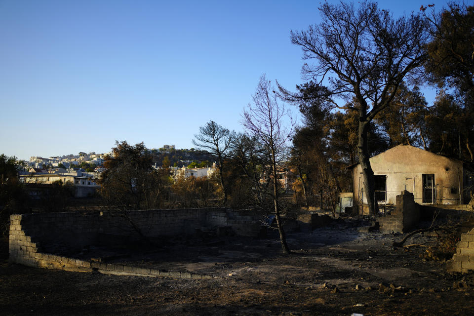 A damaged house, which had been burned in a mid-August wildfire, is seen in Halandri suburb in northern Athens, Sunday, Aug. 25, 2024. (AP Photo/Thanassis Stavrakis)