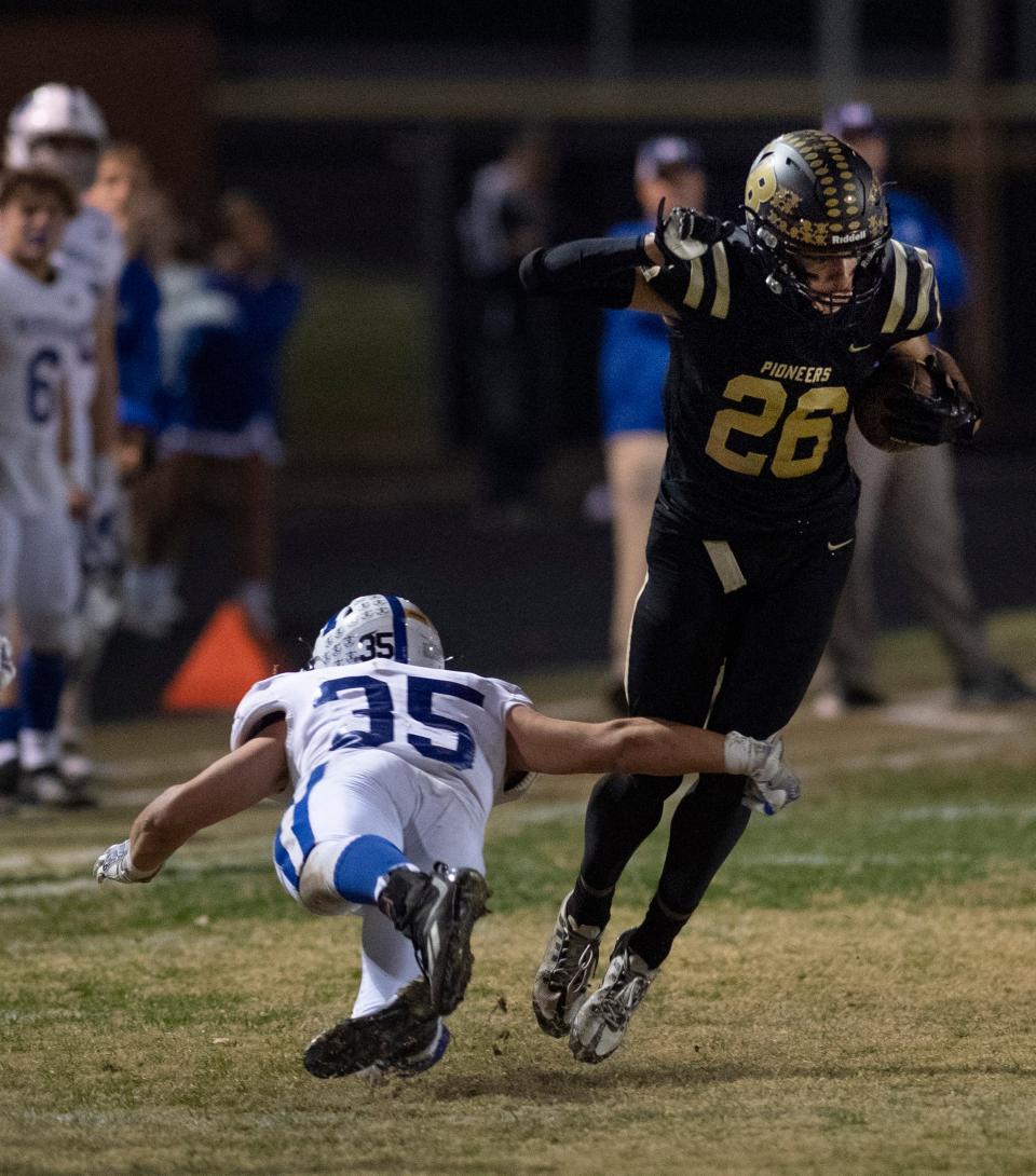 Memorial’s Alex Broshears (35) tries to take down Boonville’s Marques Ballard (26) during their IHSAA 4A Sectional Championship game at Bennett Stadium in Boonville, Ind., Friday night, Nov. 4, 2022. Memorial beat Boonville 33-14.