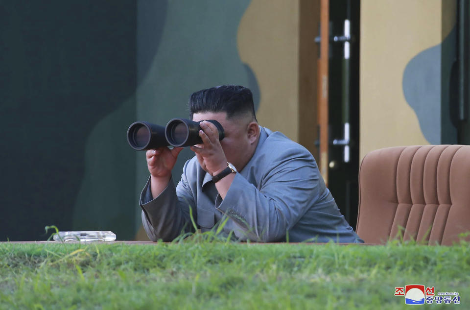 In this Thursday, July 25, 2019, photo provided on Friday, July 26, 2019, by the North Korean government, North Korean leader Kim Jong Un watches a missile test in North Korea.  A day after two North Korean missile launches rattled Asia, the nation announced Friday that its leader Kim supervised a test of a new-type tactical guided weapon that was meant to be a &quot;solemn warning&quot; about South Korean weapons introduction and its rival&#39;s plans to hold military exercises with the United States. Independent journalists were not given access to cover the event depicted in this image distributed by the North Korean government. The content of this image is as provided and cannot be independently verified. Korean language watermark on image as provided by source reads: &quot;KCNA&quot; which is the abbreviation for Korean Central News Agency. (Korean Central News Agency/Korea News Service via AP)