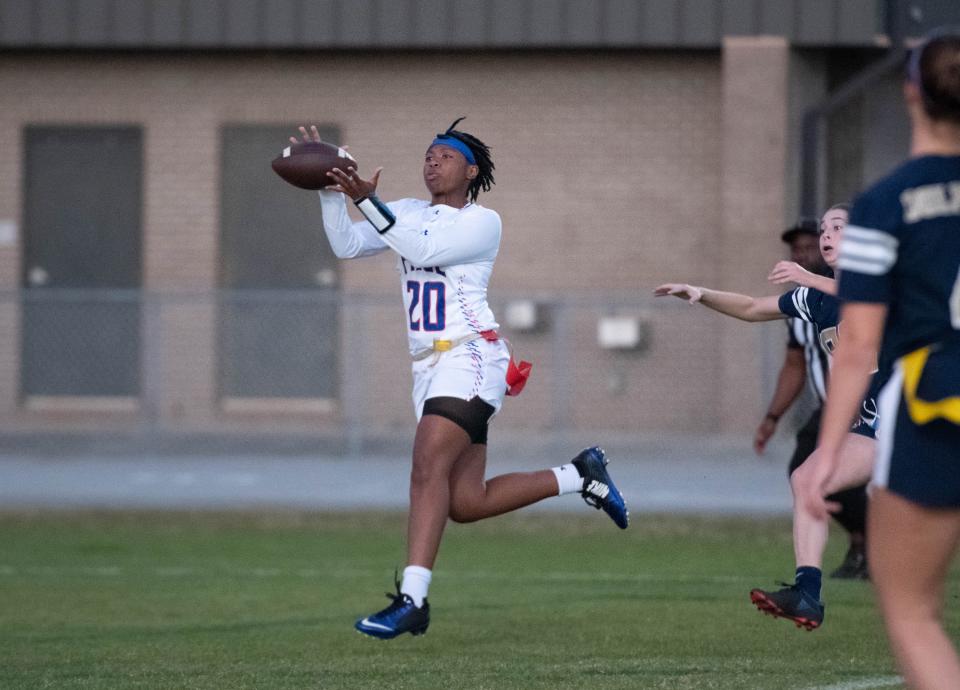 Ashten Dickerson (20) hangs on for a catch and takes it to the house for a touchdown and a 25-6 Patriots lead during the Pace vs Gulf Breeze flag football at Gulf Breeze High School on Wednesday, March 22, 2023.