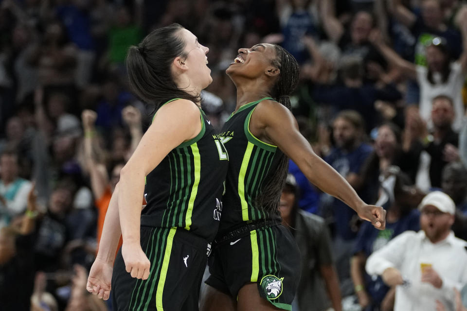 Minnesota Lynx forward Bridget Carleton, left, celebrates with guard Diamond Miller after making a 3-point basket against the Connecticut Sun during the first half of Game 3 of a WNBA first-round basketball playoff series Wednesday, Sept. 20, 2023, in Minneapolis. (AP Photo/Abbie Parr)