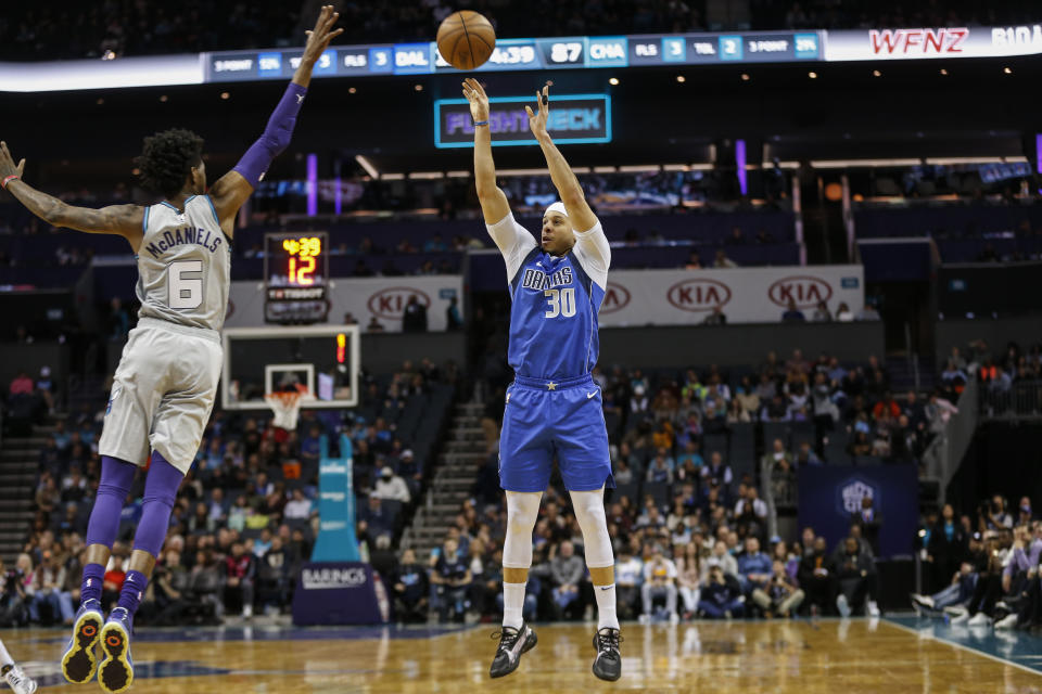 Dallas Mavericks guard Seth Curry, right, shoots over Charlotte Hornets forward Jalen McDaniels during the second half of an NBA basketball game in Charlotte, N.C., Saturday, Feb. 8, 2020. Dallas won 116-100. (AP Photo/Nell Redmond)