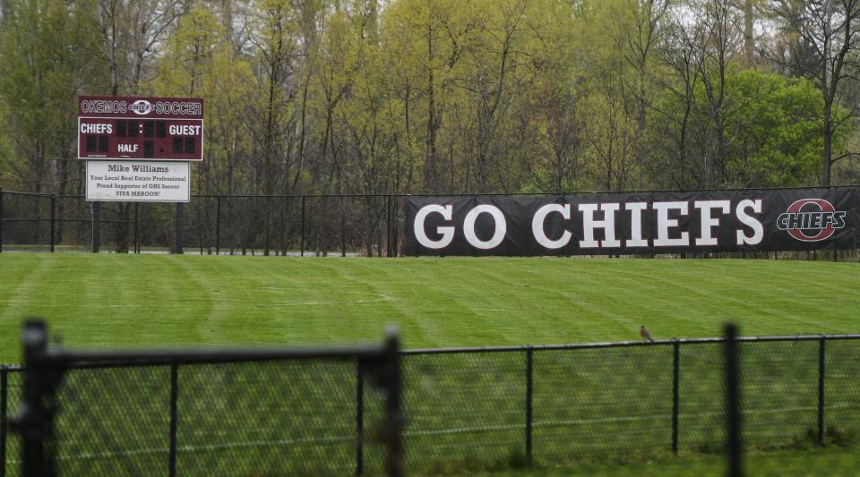 The scoreboard and signage at Okemos High School's soccer field, seen April 29, 2021.