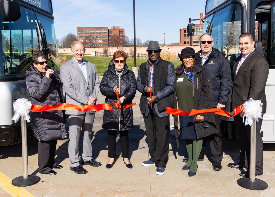 From left, Metro CEO Dawn Distler, Cuyahoga Falls Mayor Don Walters, Summit County Executive Ilene Shapiro, Metro Board President Robert DeJournett, Summit County Council District 5 Representative Veronica Sims, Stow Mayor John Pribonic and Barberton Mayor William Judge participate in a ibbon-cutting ceremony for Metro RTA's new electric buses Tuesday in Akron.