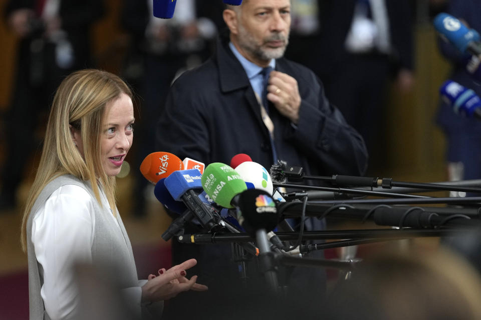 Italy's Prime Minister Giorgia Meloni speaks with the media as she arrives for an EU summit at the European Council building in Brussels, Thursday, Oct. 26, 2023. European Union leaders gather Thursday for a two day meeting to discuss, among other issues, Ukraine and the impact of the war between Israel and Hamas. (AP Photo/Virginia Mayo)