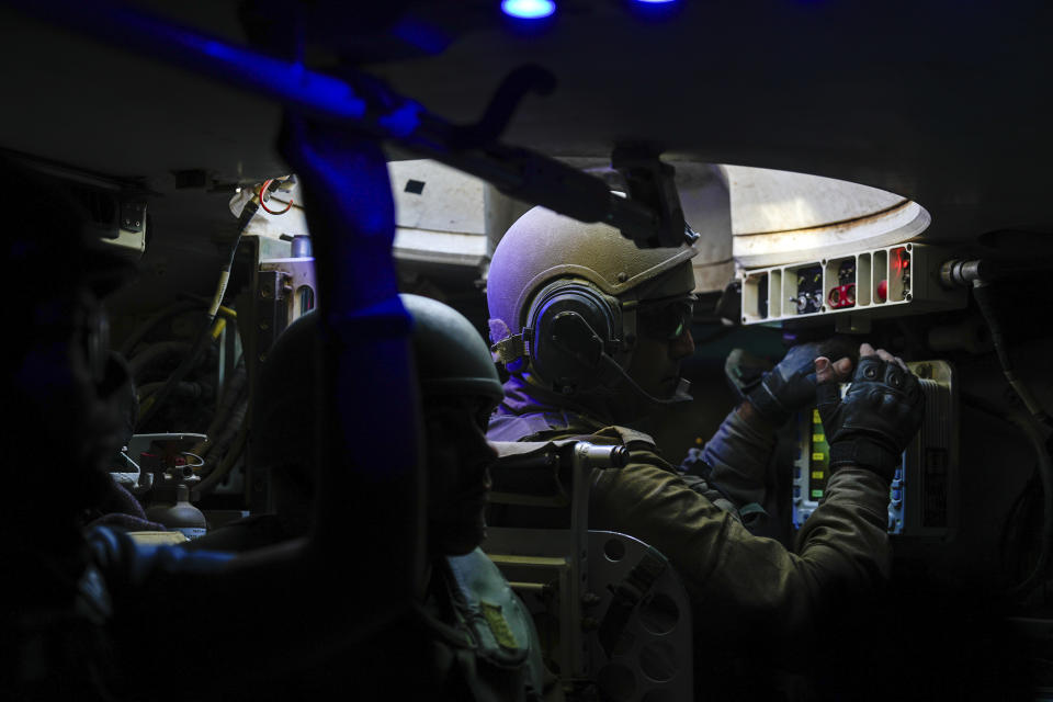 Israeli soldiers are seen in an armored personnel carrier during a ground operation in the Gaza Strip, Wednesday, Nov. 8, 2023. Israeli ground forces entered the Gaza Strip as they press ahead with their war against Hamas militants in retaliation for the group's unprecedented Oct. 7 attack on Israel. (AP Photo/Ohad Zwigenberg)