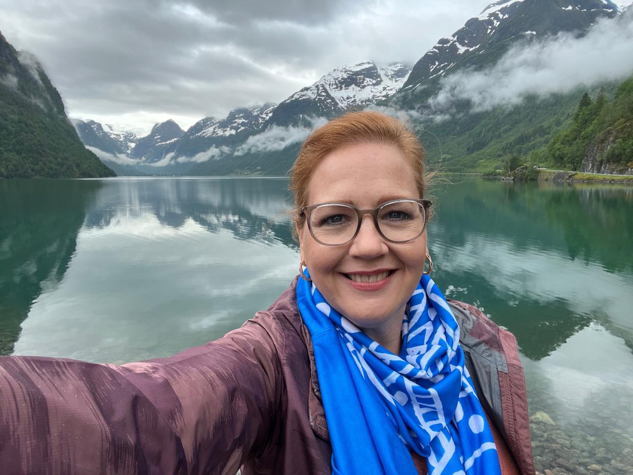 Photo of leslie walker in front of the Briksdal Glacier in the distance