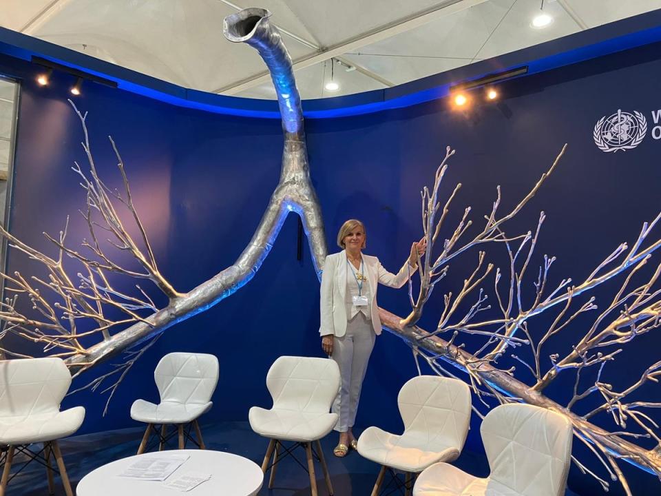 Dr Maria Neira stands next to the giant sculpture of lungs in the World Health Organisation pavilion at Cop27 (Saphora Smith)