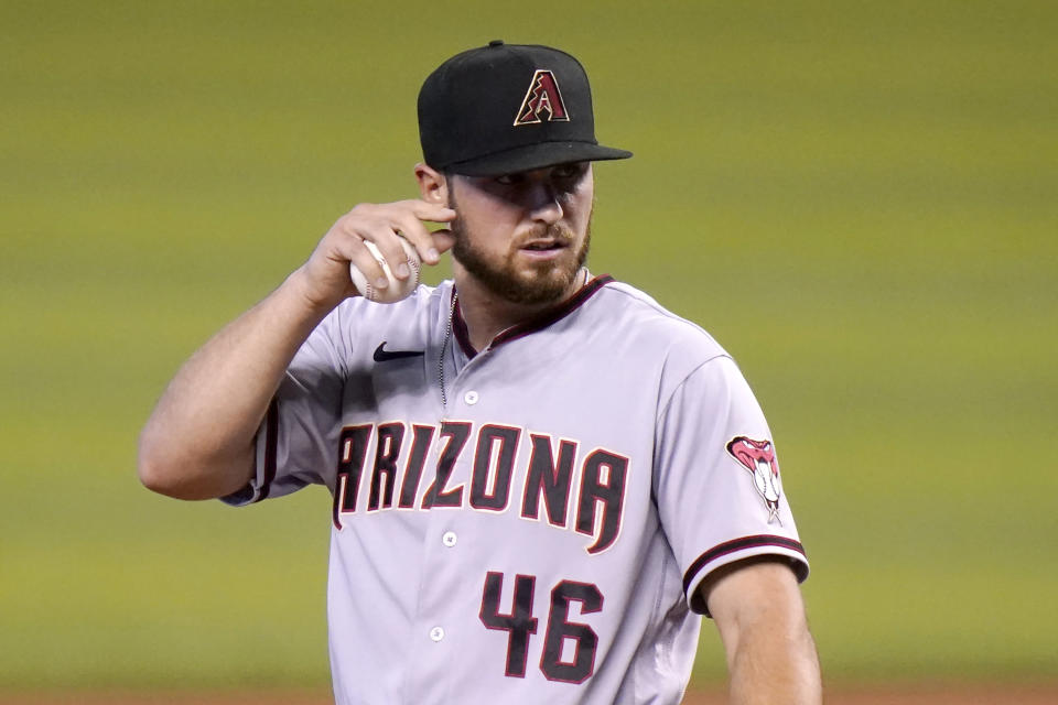 Arizona Diamondbacks starting pitcher Riley Smith (46) reacts after giving up a single to Miami Marlins' Adam Duvall during the first inning of a baseball game, Tuesday, May 4, 2021, in Miami. (AP Photo/Lynne Sladky)