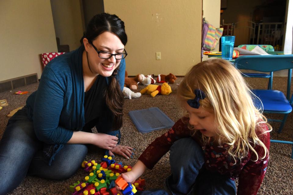 Krystal Trull plays with daughter Nikole Trull, 4, at their house in Sioux Falls, S.D.
