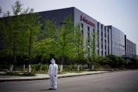 Worker in a protective suit is seen at a Dongfeng Honda factory in Wuhan