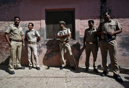 Policemen stand guard near the house of Akhalaq Saifi, who was killed by a mob, at Bisara village in Uttar Pradesh, India, October 2, 2015. REUTERS/Anindito Mukherjee