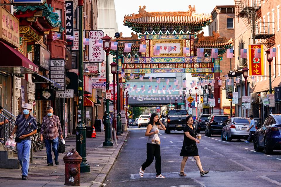 FILE - Pedestrians cross 10th Street in the Chinatown neighborhood of Philadelphia on July 22, 2022. Philadelphia officials announced on Wednesday, April 12, 2023, “an independent and comprehensive evaluation” of the Philadelphia 76ers’ proposal to build a $1.3 billion sports arena next to the city's Chinatown neighborhood, an idea that's drawn strong opposition from some Chinatown residents and leaders. (AP Photo/Matt Rourke, File)