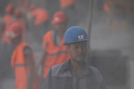 A construction worker looks on at the construction site of Samara Arena stadium in Samara, Russia August 23, 2017. REUTERS/Maxim Shemetov