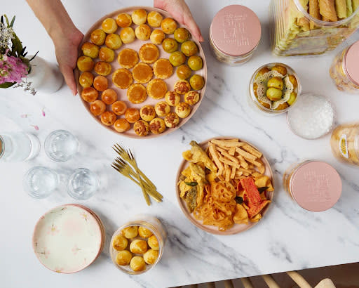 cny - placing tarts on the table