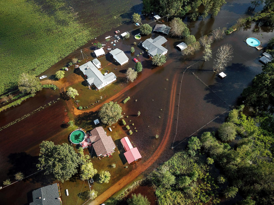 A flooded neighborhood stands next to the Black Swamp River in Lumberton.&nbsp;