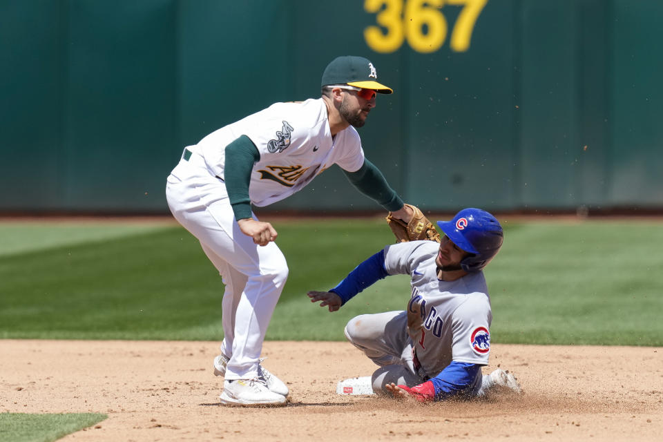 Chicago Cubs' Nick Madrigal, right, is tagged out at second by Oakland Athletics shortstop Kevin Smith on a steal-attempt during the fifth inning of a baseball game in Oakland, Calif., Wednesday, April 19, 2023. (AP Photo/Godofredo A. Vásquez)