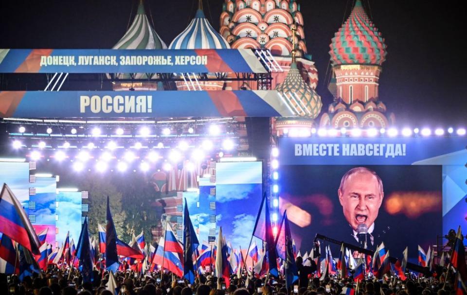 Russian President Vladimir Putin is seen on a screen set at Red Square as he addresses a rally and a concert marking the annexation of four regions of Ukraine Russian troops occupy - Luhansk, Donetsk, Kherson and Zaporizhzhia, in central Moscow on Sept. 30, 2022. (Alexander Nemenov/AFP via Getty Images)