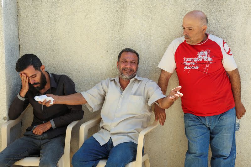 A relative of Mustafa Misto, a Lebanese man who, with his wife and three young children, was on the migrant boat which according to Lebanese and Syrian officials sank off the Syrian coast after sailing from Lebanon, reacts in the northern city of Tripoli