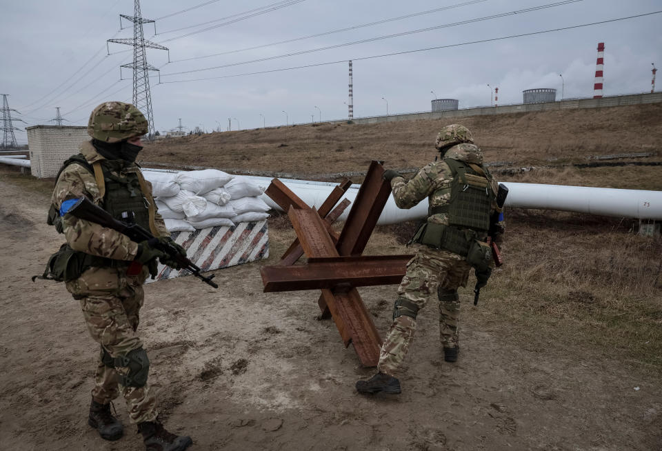 Ukrainian servicemen by a gun emplacement and a bank of sandbags during joint drills of Ukraine's armed forces, national guard and Security Service near its border with Belarus.