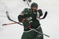 Minnesota Wild right wing Ryan Hartman (38) celebrates with defenseman Jared Spurgeon (46) after Hartman scored a goal against the Chicago Blackhawks during the third period of an NHL hockey game Saturday, March 25, 2023, in St. Paul, Minn. Minnesota won 3-1. (AP Photo/Stacy Bengs)