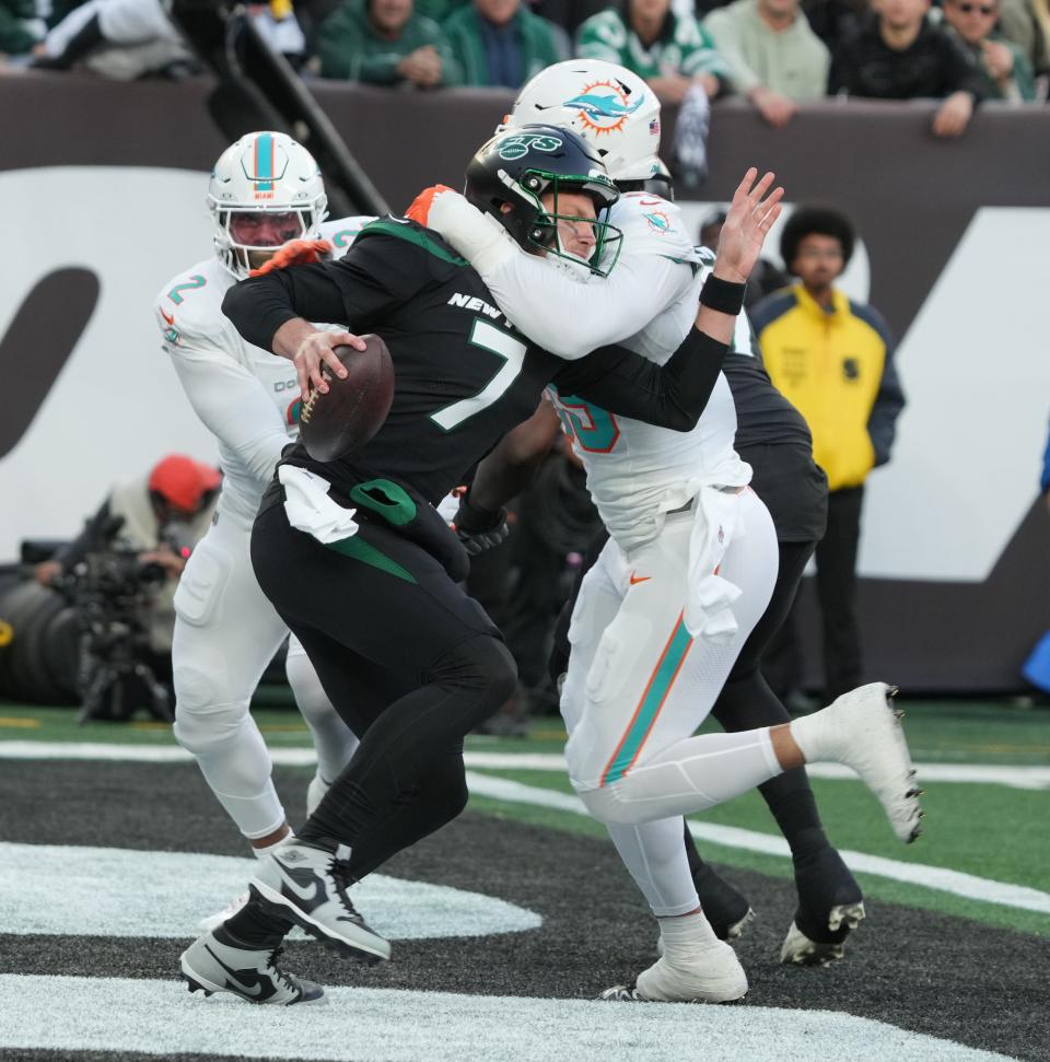 East Rutherford, NJ — November 24, 2023 -- Jets quarterback Tim Boyle is wrapped up by Jaelan Phillips of Miami but manages to get rid of the ball for an incomplete pass in the first half as the Miami Dolphins defeated the NY Jets 34-13 at MetLife Stadium on November 24, 2023 in East Rutherford, NJ to play in the first “Black Friday” NFL game.