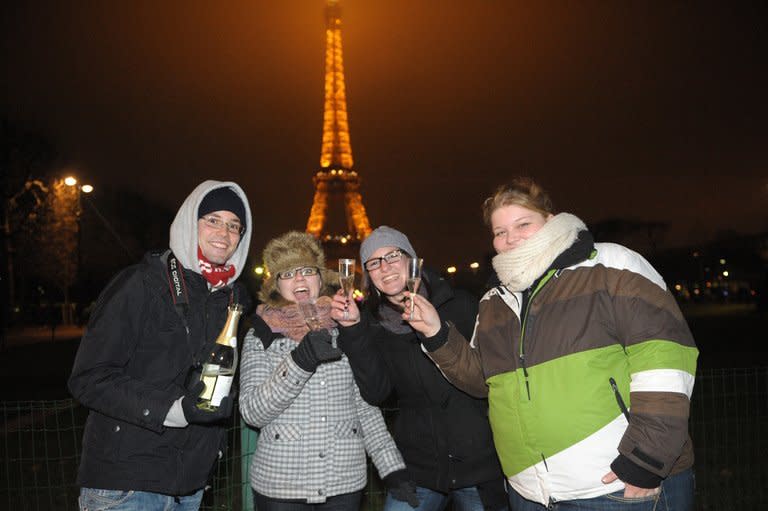 People celebrate New Year's Even with champagne near the Eiffel Tower in Paris last year. ne of the world's oldest shared traditions, New Year's celebrations take many forms, but most cultures have one thing in common -- letting one's hair down after a long, hard year