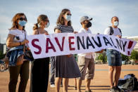 Protesters hold a sign during a peaceful rally to speak up against political repressions, human rights violations and antidemocratic rule in Russia, during a demonstration in Geneva, Switzerland, Tuesday, June 15, 2021. Geneva is hosting a meeting between U.S. President Biden and Russian President Putin on June 16. A couple dozen supporters of Navalny, the jailed Russian opposition leader, staged a rally Tuesday on a sun-drenched Geneva square.(Magali Girardin/Keystone via AP)