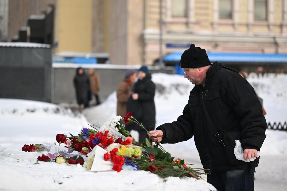 People came to lay flowers for Alexei Navalny at the Solovetsky Stone, a monument to political repression in Moscow (AFP via Getty Images)