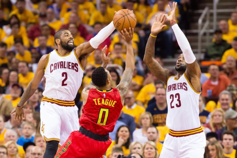 Kyrie Irving (L) scored 21 points with eight assists and one rebound as the well-rested Cavaliers dominated against a weary Atlanta