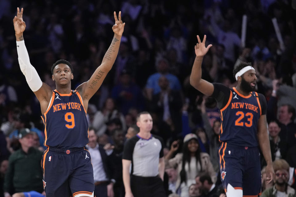 New York Knicks guard RJ Barrett (9) and center Mitchell Robinson (23) react in the first half of an NBA basketball game against the Miami Heat, Wednesday, March 29, 2023, at Madison Square Garden in New York. (AP Photo/Mary Altaffer)