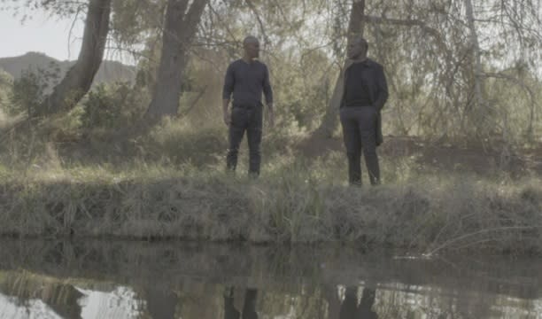 Morgan and Hank stand outside a lake of memories in episode 16, season 11 of Criminal Minds.