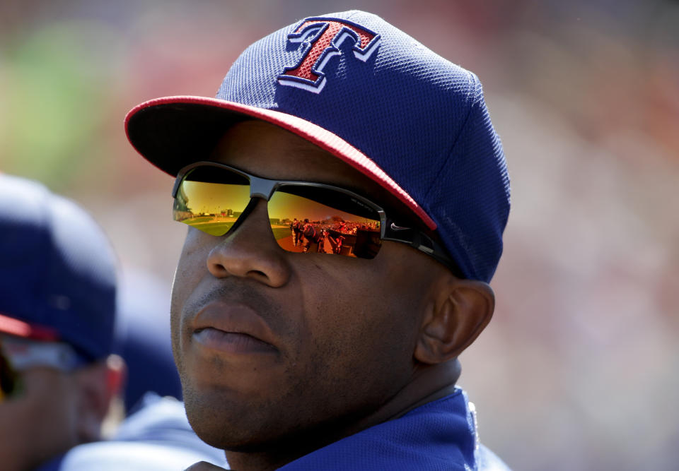FILE - In this March 16, 2015 file photo, Texas Rangers center fielder Antoan Richardson waits in the dugout during the first inning of a spring training baseball exhibition game against the Los Angeles Angels in Tempe, Ariz. The San Francisco Giants believe they might be making a little major league history this spring: as the first team with uniform numbers 0 and 00 in the same year. When San Francisco added speedy outfielder Billy Hamilton on a minor league deal earlier this month, equipment manager Brad Grems called the league to make sure there's a difference between the two, because new first base coach Antoan Richardson had claimed 00 already. (AP Photo/Chris Carlson, File)