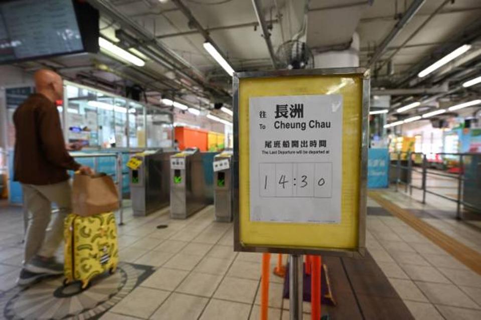 A sign shows the time of the last ferry to the outlying island of Cheung Chau as Hong Kong hoisted typhoon signal no 8 around noon on 8 October 2023 (AFP via Getty Images)