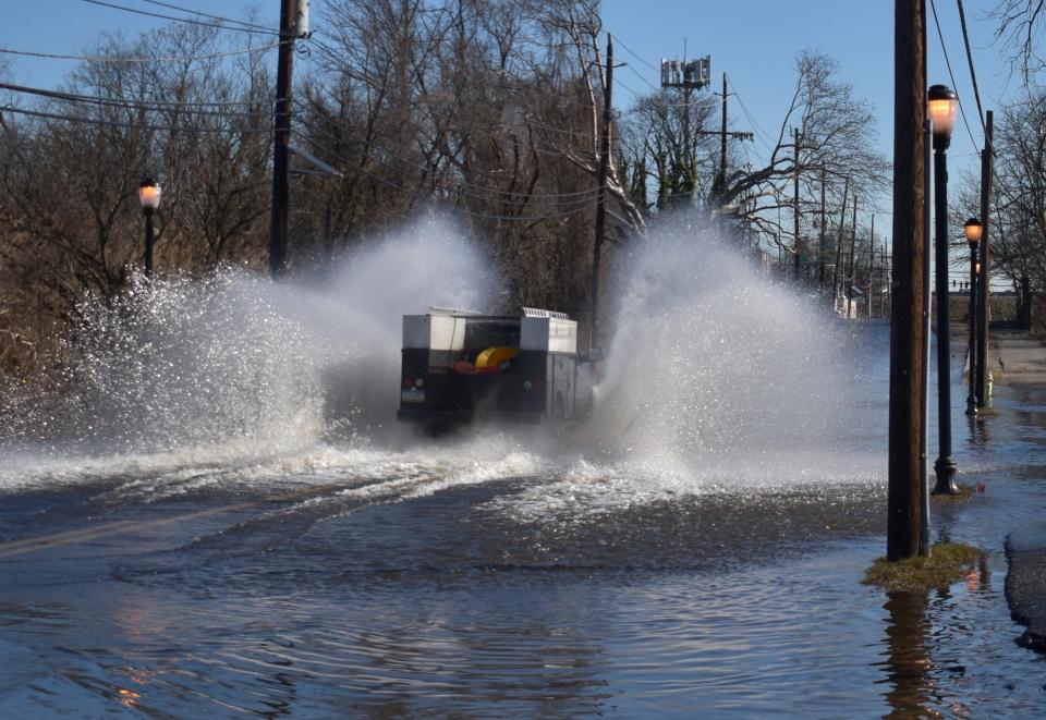 A driver plunges through tidal flooding on Kaighn Avenue in Camden on Feb. 7, 2024.