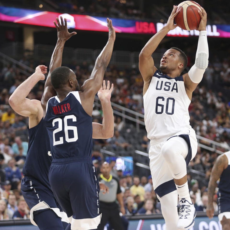 Team White guard Jalen Brunson (60) goes up for a shot under pressure from Team Blue guard Kemba Walker (26) during the first half of the U.S. men's basketball team's scrimmage in Las Vegas, Friday, Aug. 9, 2019. (Erik Verduzco/Las Vegas Review-Journal via AP)