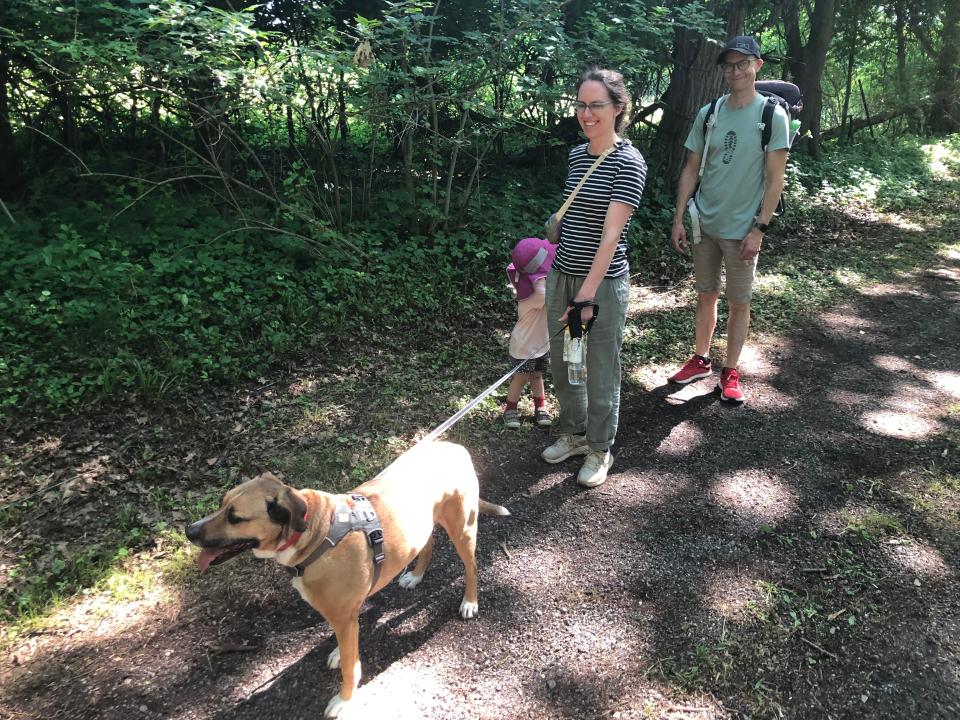 Frances Jacobus-Parker and Marius Hauknes take a family walk on the preliminary trails, including this dirt drive, at the Portage Manor property in South Bend during an open house for trails on June 15, 2024.