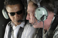 Then U.S. Senator Barack Obama listens (L) as Gen. David Petraeus (R) discusses security improvements in Baghdad while giving him an aerial tour of the city, in this July 21, 2008 file photo. U.S. President Obama has chosen Petraeus to replace Gen. Stanley McChrystal as the top U.S. general in Afghanistan, the president announced on June 23, 2010. Picture taken July 21, 2008. REUTERS/Lorie Jewell/Multi-National Forces Iraq Public Affairs/Handout