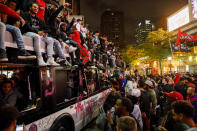 TORONTO, ON - JUNE 14: Toronto Raptors fans celebrate atop and inside a bus on Yonge St. after the team beat the Golden State Warriors in Game Six of the NBA Finals, on June 14, 2019 in Toronto, Canada. (Photo by Cole Burston/Getty Images)