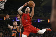 Portland Trail Blazers guard Josh Hart (11) drives to the basket past New York Knicks center Isaiah Hartenstein during the first half of an NBA basketball game Friday, Nov. 25, 2022, in New York. (AP Photo/Adam Hunger)