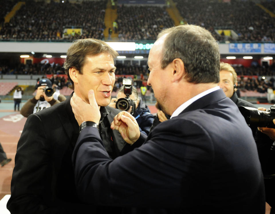 Napoli coach Rafael Benítez, right, and AS Roma coach Rudi Garcia share a light moment before the start of a Serie A soccer match between Napoli and Roma, at the San Paolo stadium in Naples, Italy, Sunday, March 9, 2014. (AP Photo/Salvatore Laporta)
