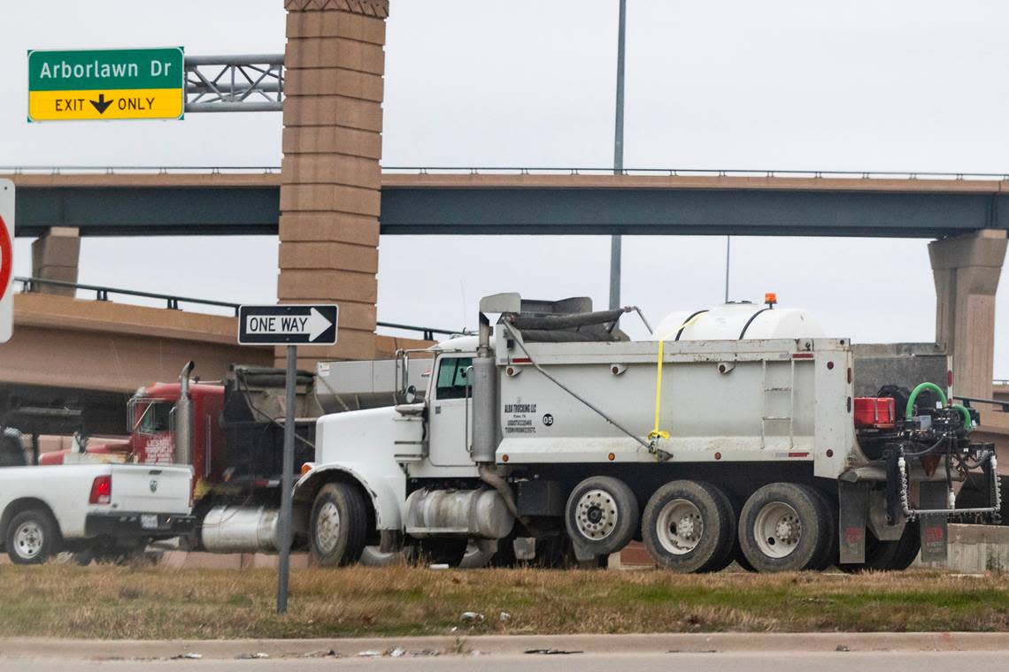 Crews work on conditioning the freeways for expected icy weather conditions near the on-ramp onto eastbound Interstate 20 in Fort Worth on Sunday, Jan. 14, 2024.