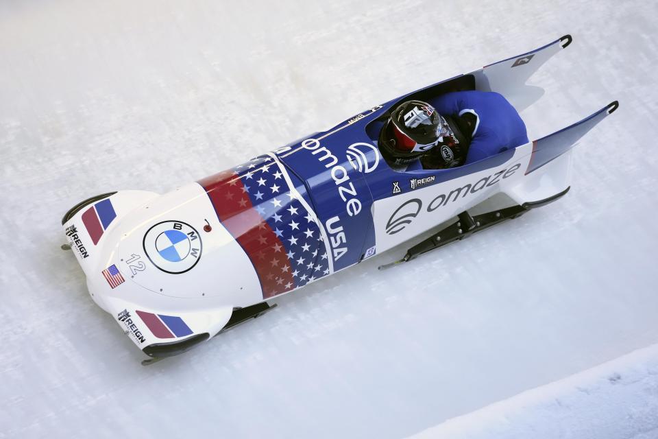 Kaillie Humphries and Sylvia Hoffman of the United States speed down the track during the women's two-women bobsleigh World Cup race in Igls, near Innsbruck, Austria, Sunday, Nov. 21, 2021. (AP Photo/Matthias Schrader)