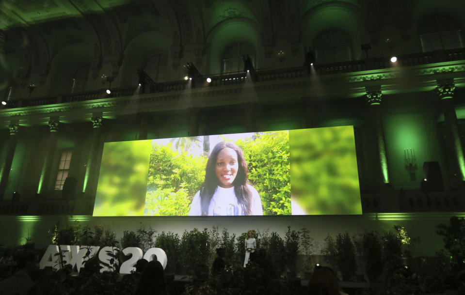 Climate activist Vanessa Nakate is seen on a giant screen as she speaks at the 'Austrian World Summit' at the Spanish Riding School in Vienna, Austria, Thursday, Sept. 17, 2020. (AP Photo/Ronald Zak)